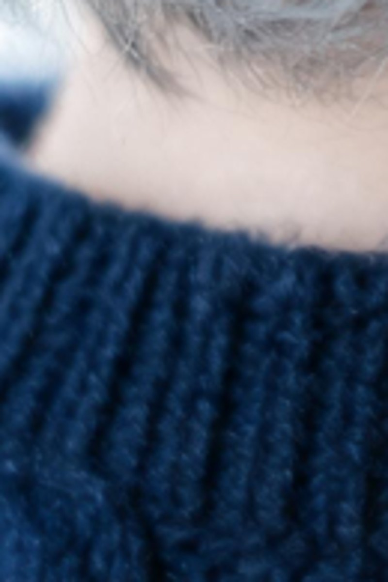 Close crop of soft grey hair above a ribbed knit collar before enhancement, enlarged for display